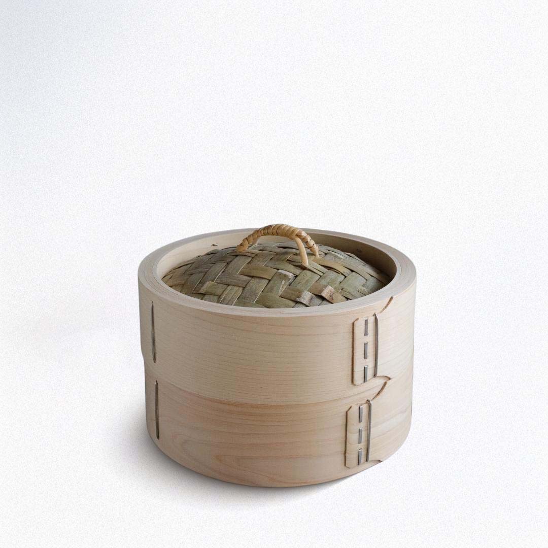 Bamboo steamer with woven lid on a white background