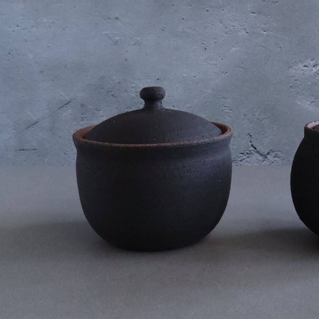 black ceramic of salt pot in a grey room