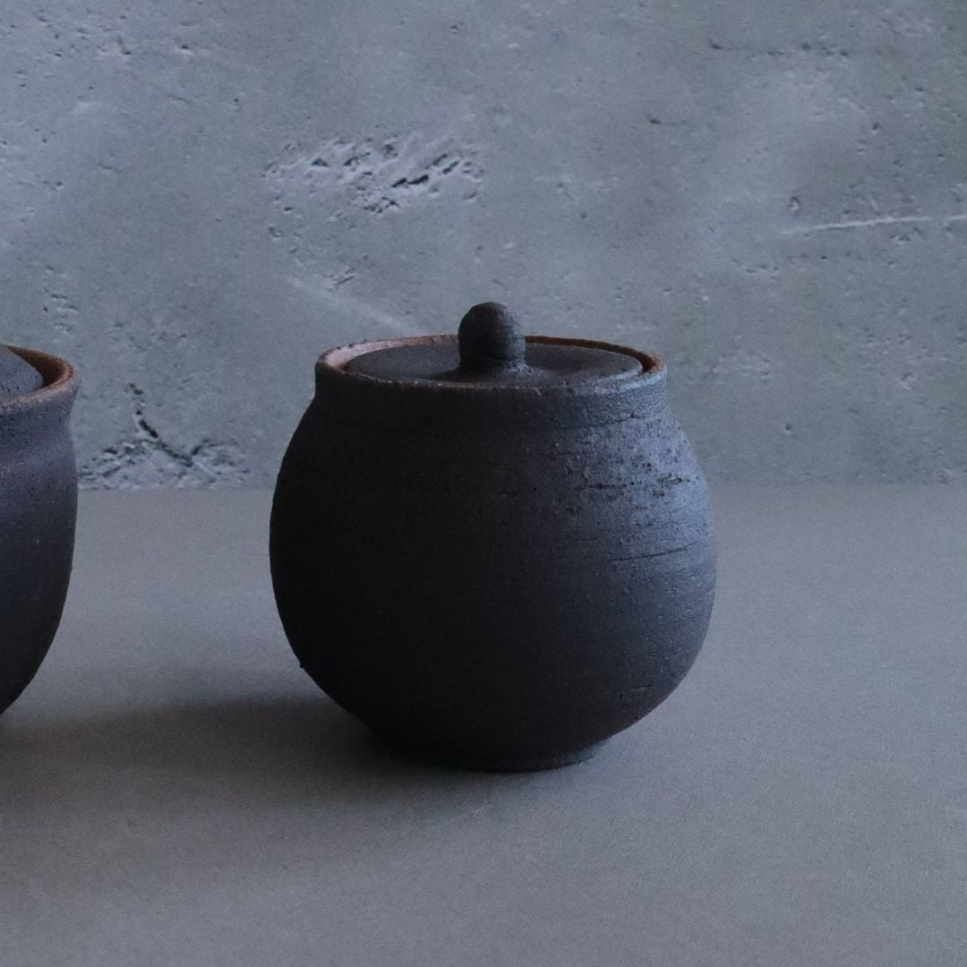 black ceramic salt pot in a grey room