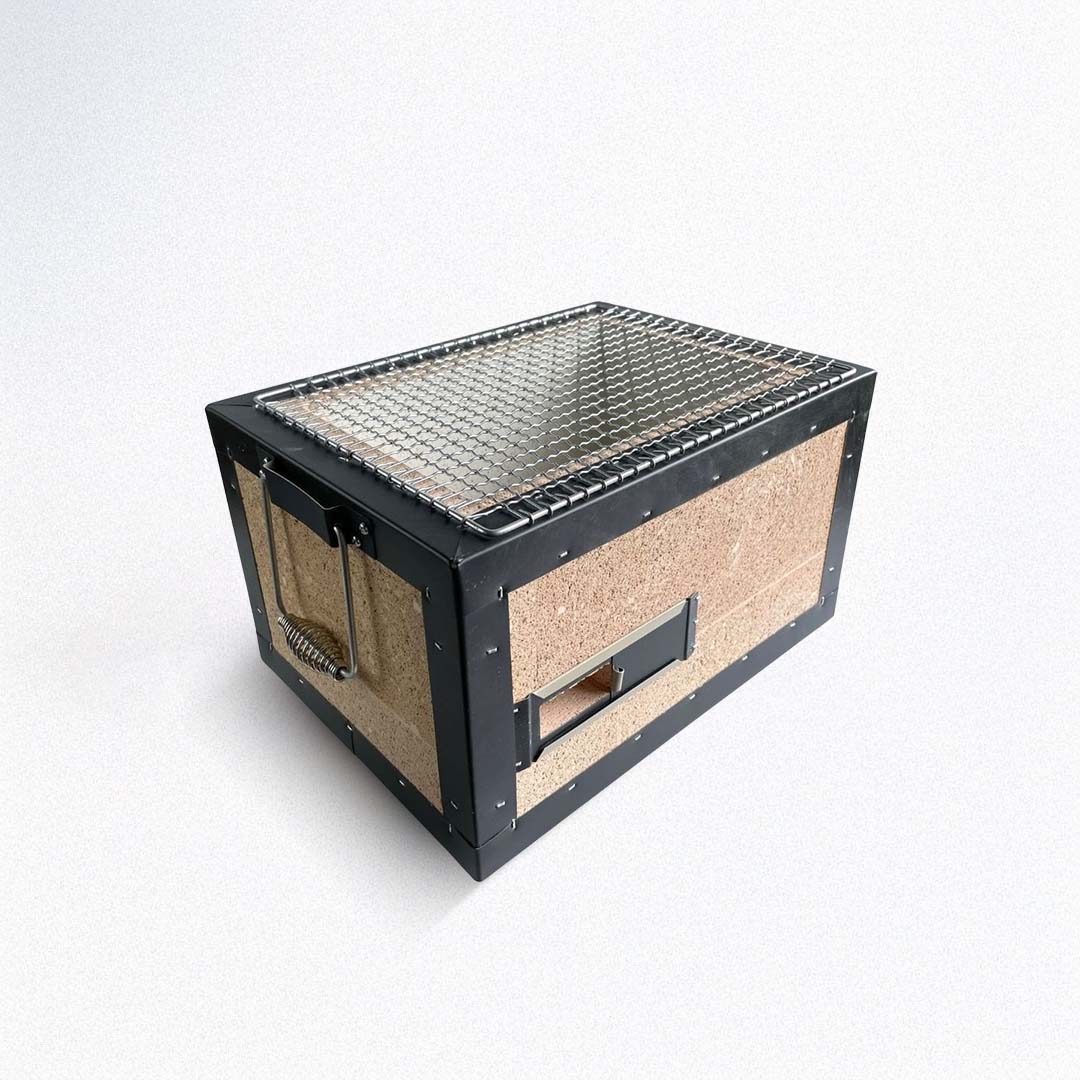 Charcoal grill with metal top and cork sides on a white background