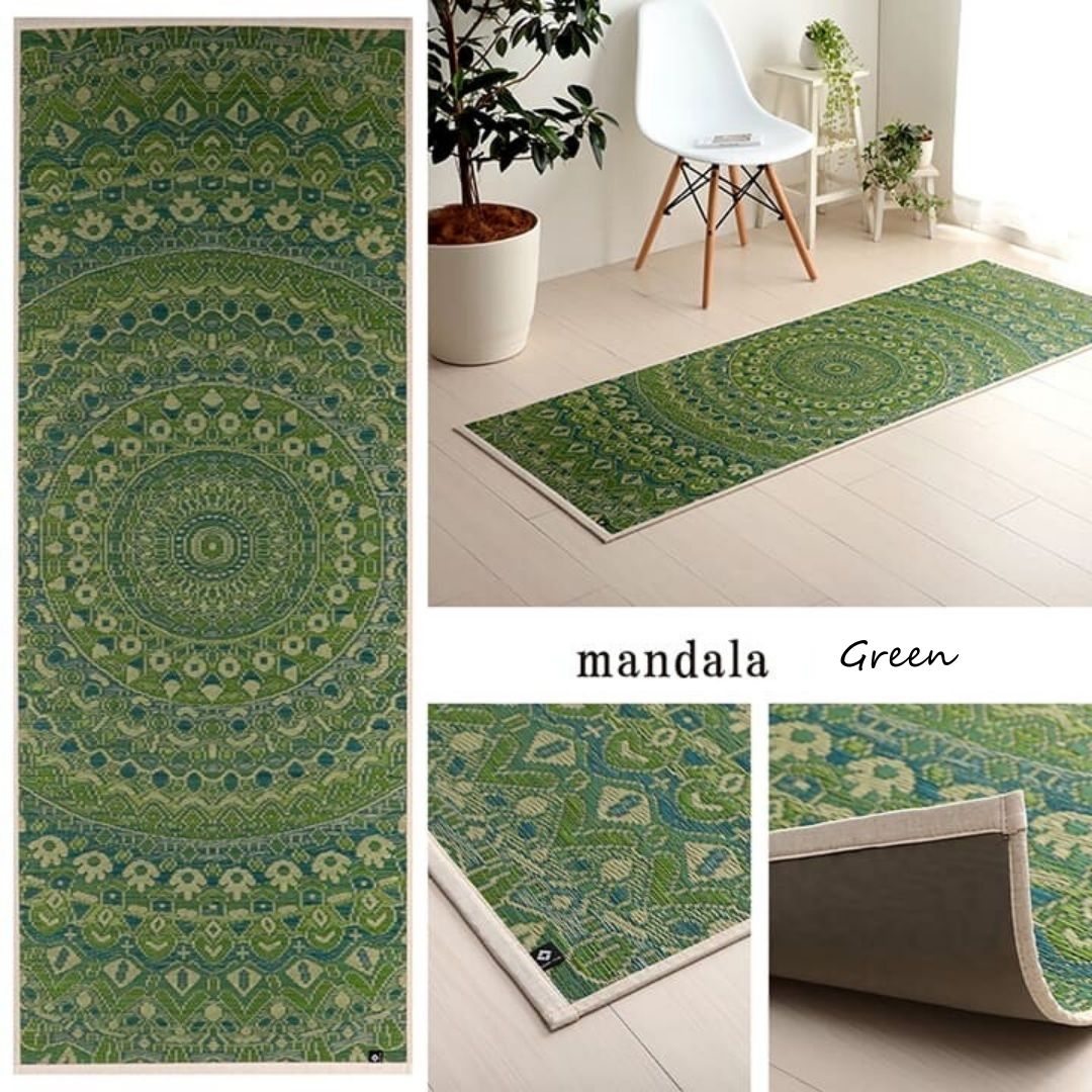 Green mandala patterned rug displayed in a room setting with a chair and plant.