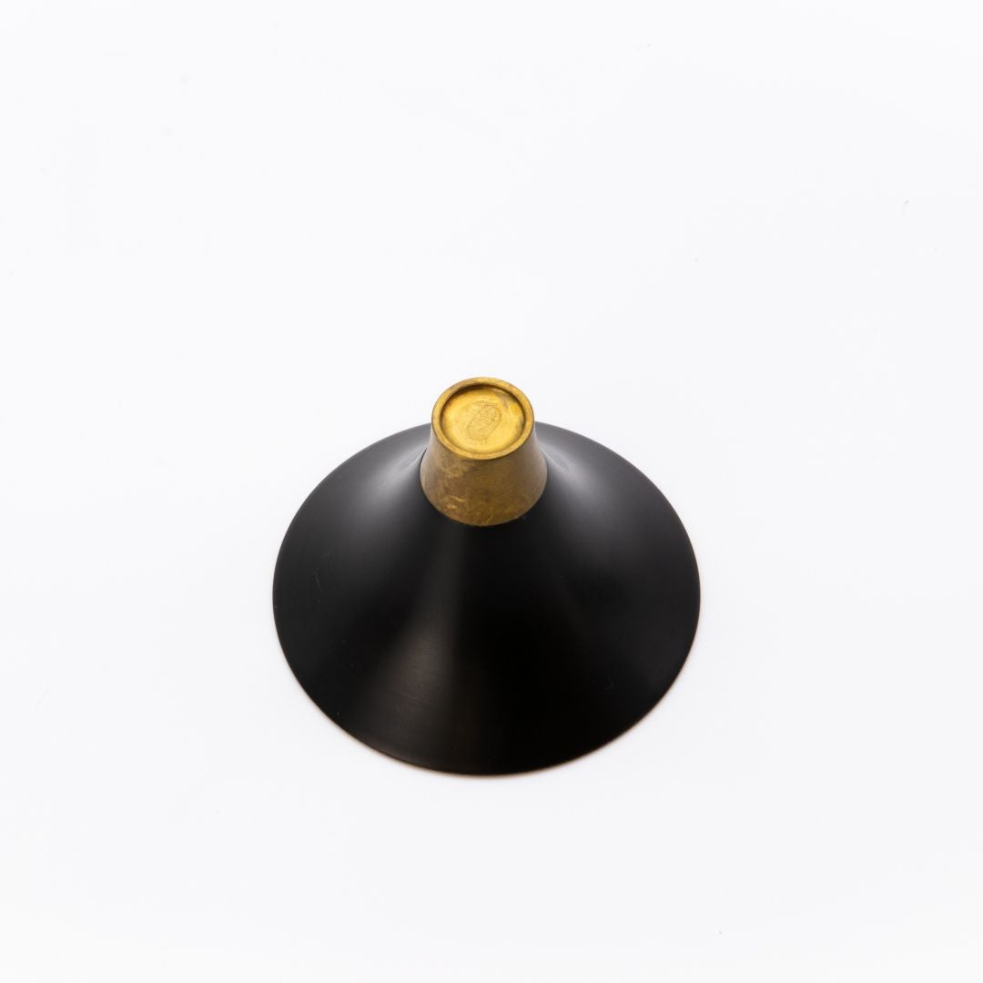 Black and gold decorative object on a white background