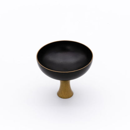 Black Sake cup with a gold base on a white background