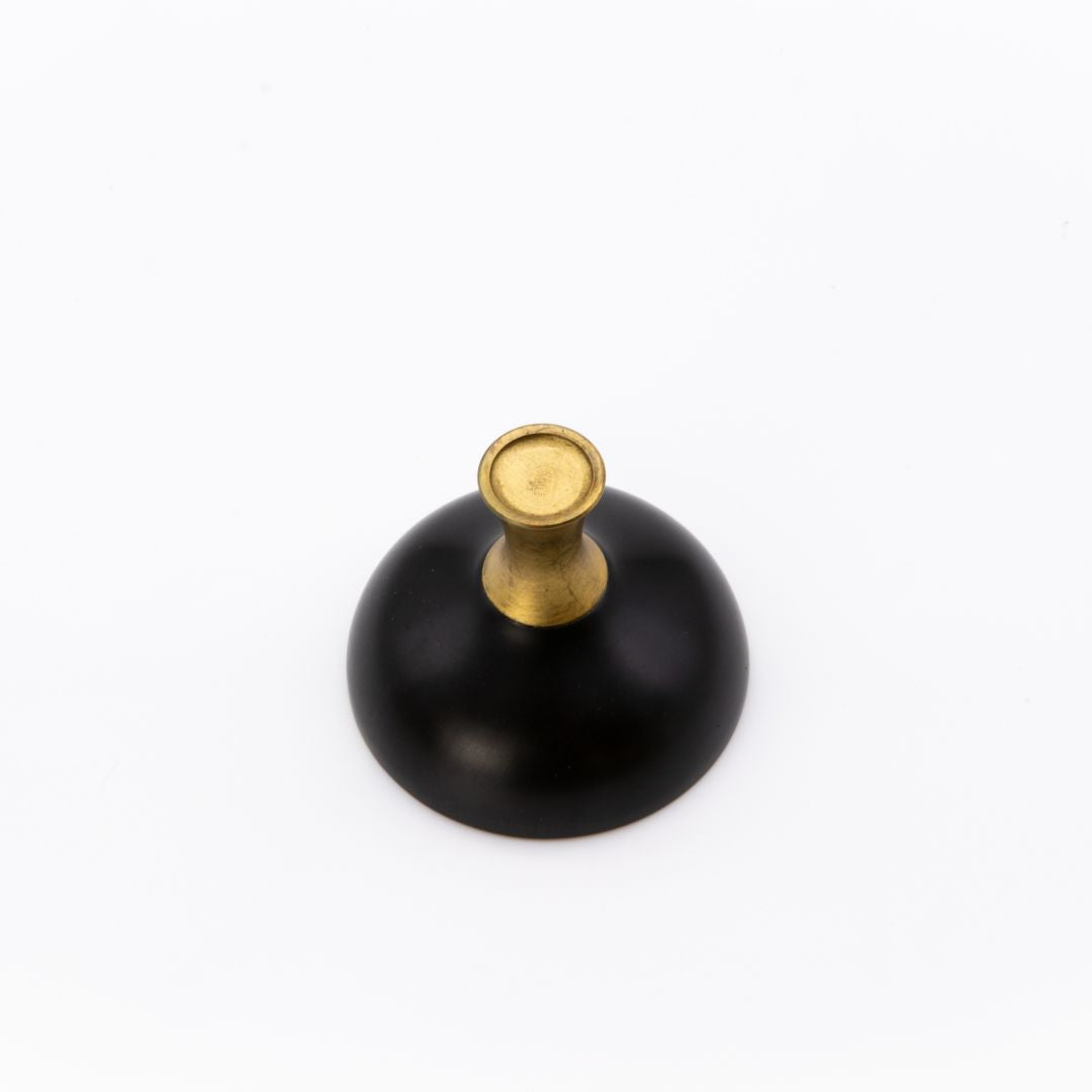 Black cup with a gold top on a white background
