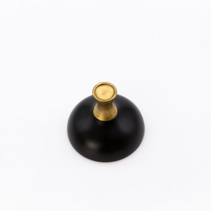 Black cup with a gold top on a white background