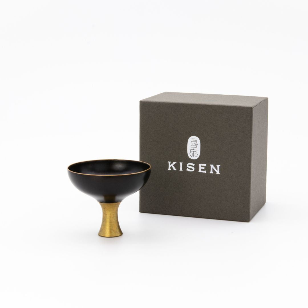 Gray box with text and Black Sake cup with a gold base on a white background