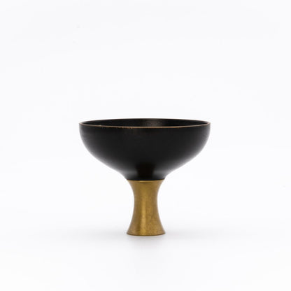 Black Sake cup with a gold base on a white background