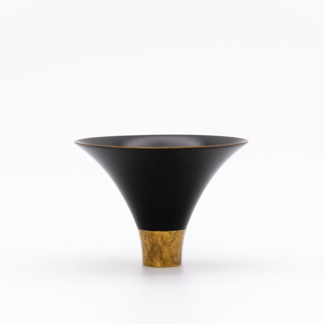 Black and gold lacquered bowl on a white background