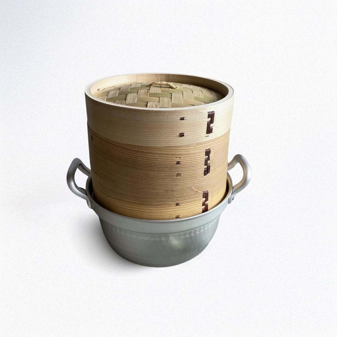 a brown bamboo steamer basket made of wood on top of an aluminum basket
