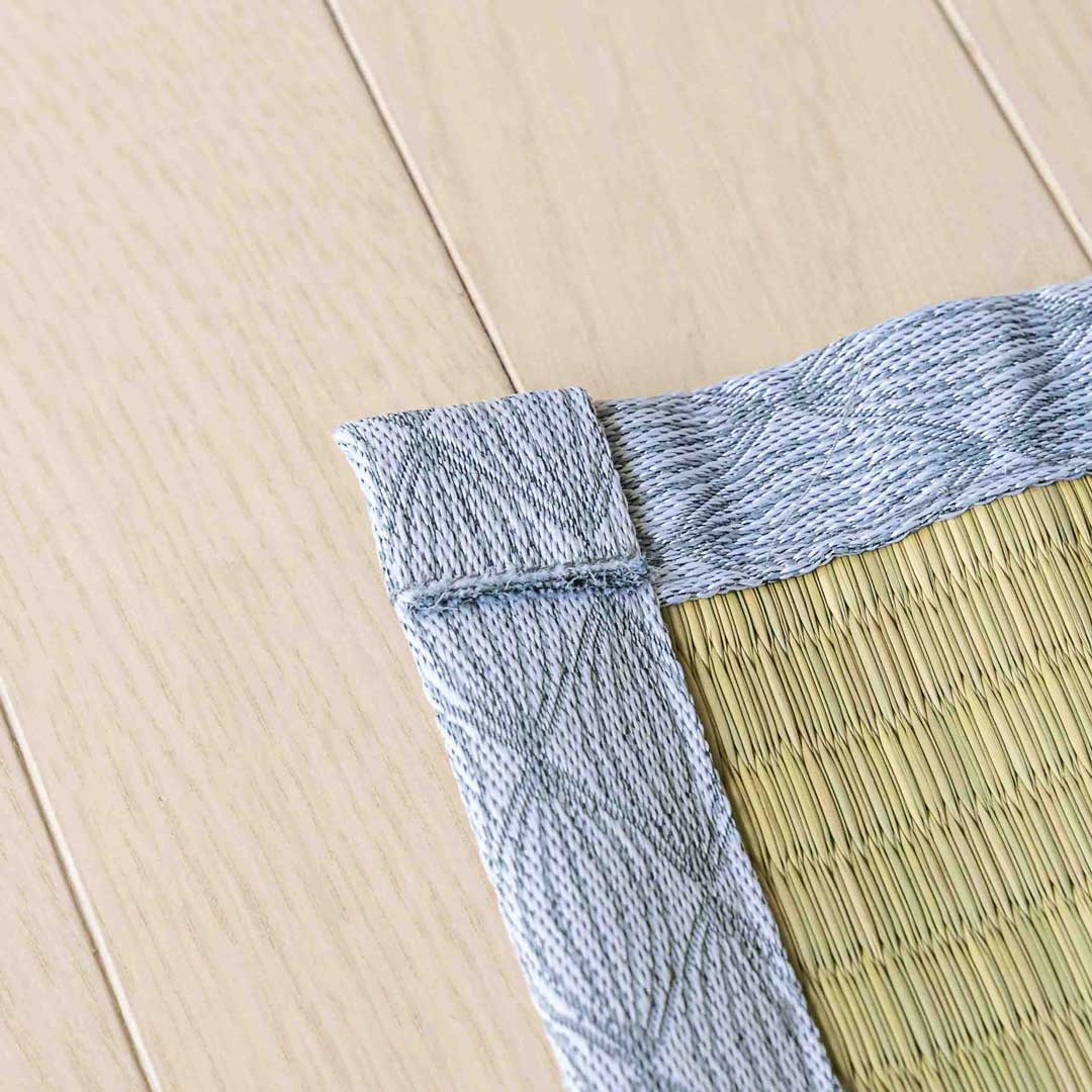 a corner of a gray colour japanese tatami Ando placed on a wooden floor