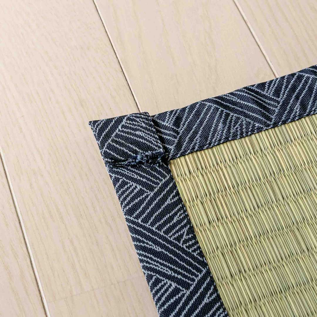 a corner of a navy colour japanese tatami Ando placed on a wooden floor