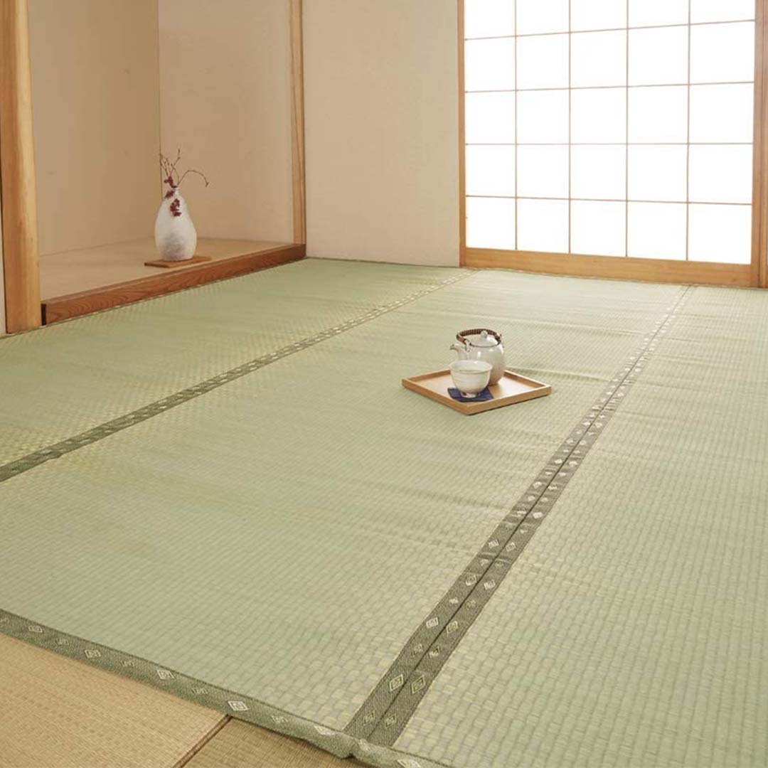 Traditional Japanese room with tatami mats and a small tea set on a tray.