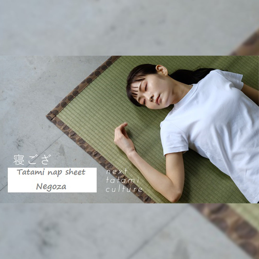 Woman peacefully sleeping on a green tatami mat, surrounded by a serene ambiance - natural tatami on a cool grey floor.