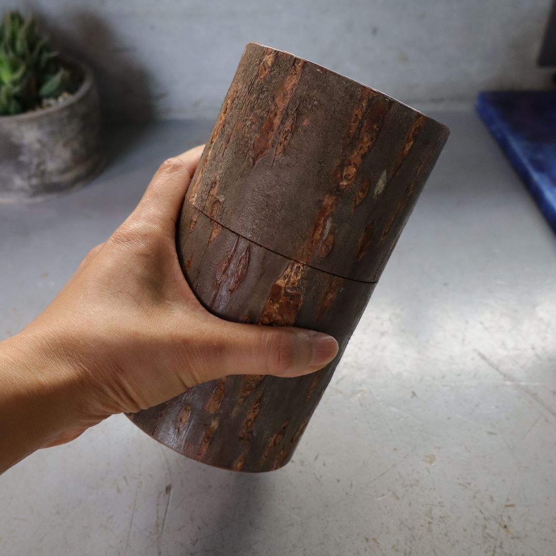 cherry bark tea caddy hold by an hand