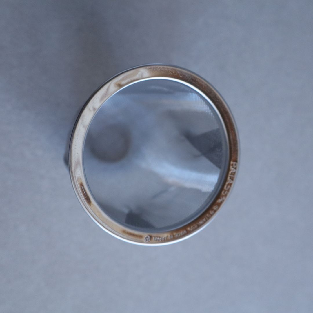 Silver ring with a reflective surface on a gray background
