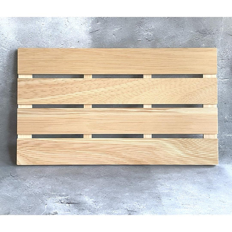 A vertical handcrafted wooden bath mat featuring several parallel slats secured by perpendicular supports, displayed against a textured gray backdrop.