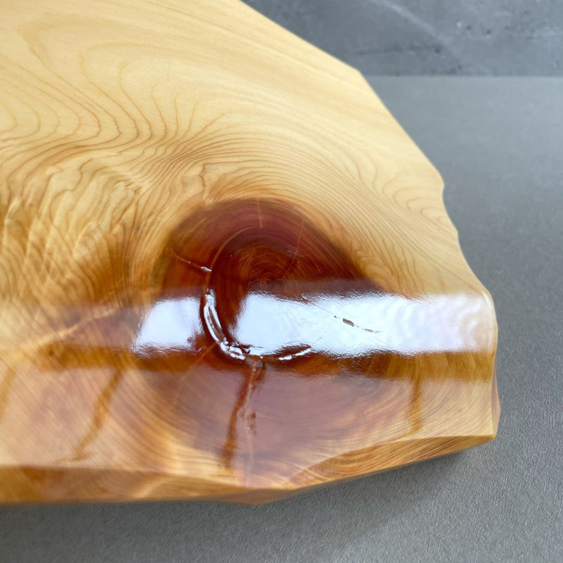 In a grey room, a close-up view of a wooden sushi tray