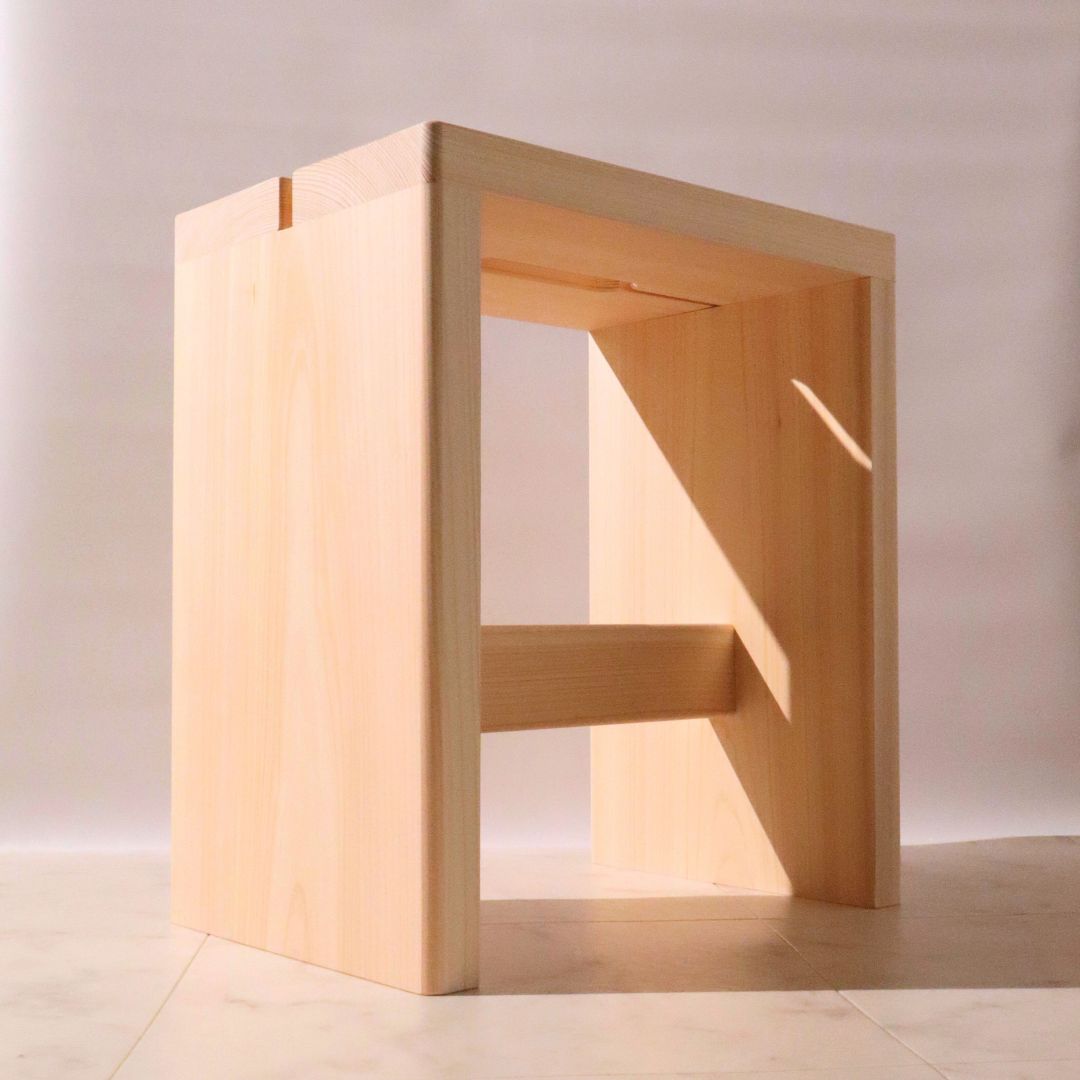 Wooden stool with a minimalist design on a light background