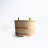 A wooden rice bucket on a white background