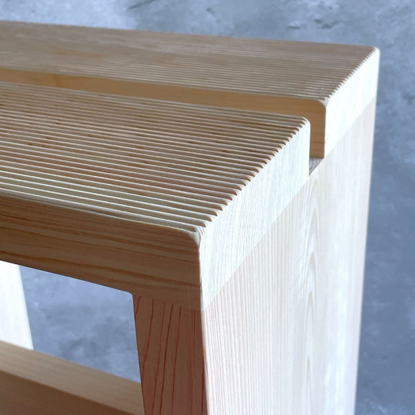 Close-up of the top portion of a wooden bath stool.