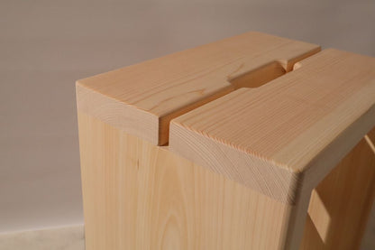 Close-up of a wooden stool with a plain background