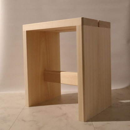 Wooden stool with a minimalist design on a neutral background