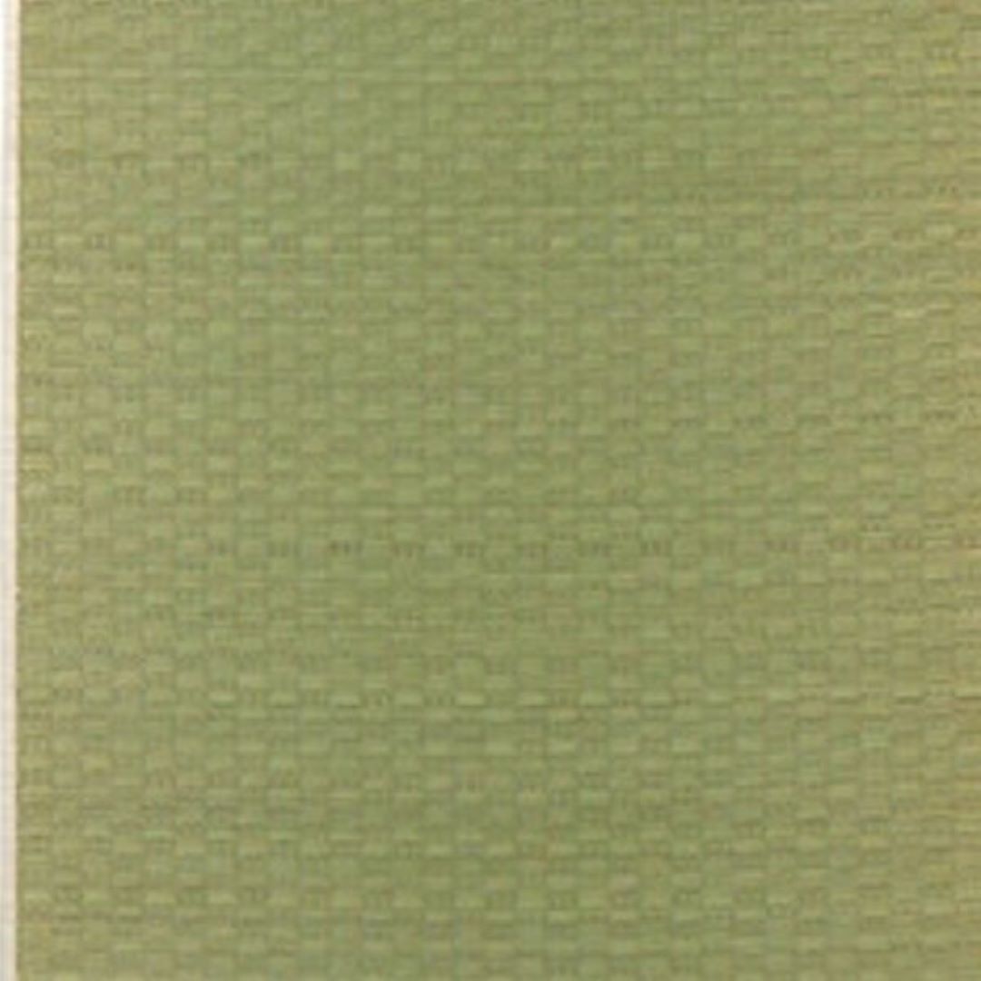 Close-up view of a Japanese rush grass tatami mat, showcasing its intricate checkered weave pattern in a natural green hue. The texture highlights the fine craftsmanship and durability of the material.