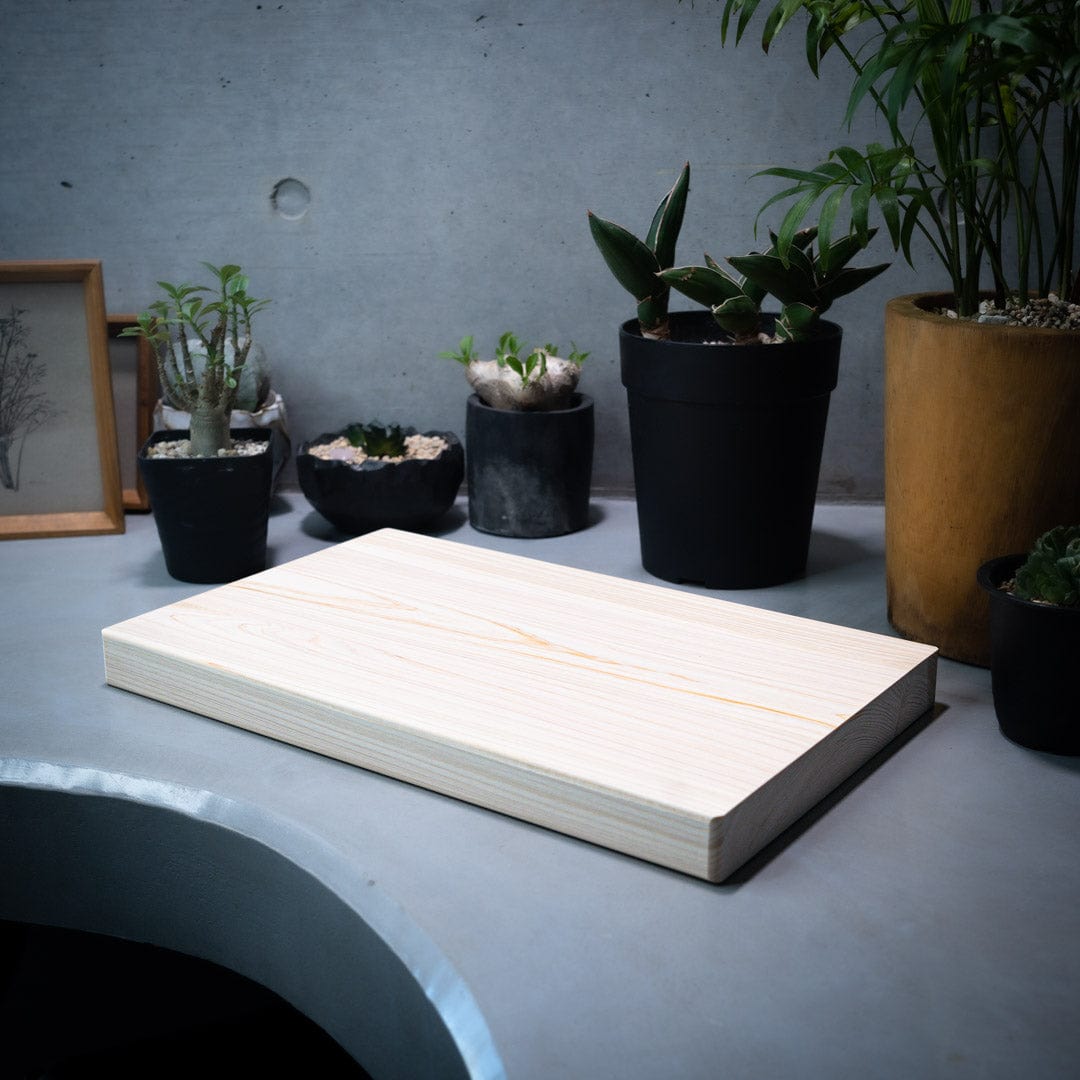 wooden cutting board in a japanese kitchen surrounded by plants
