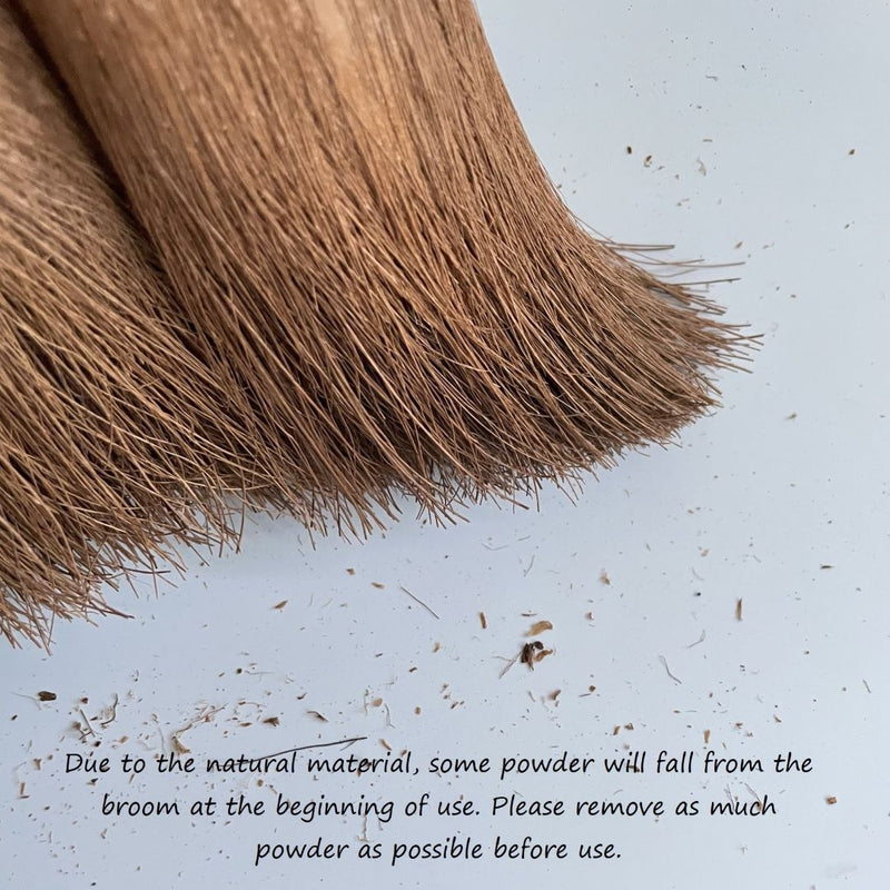 hemp broom with dust hemp on the floor in a grey background