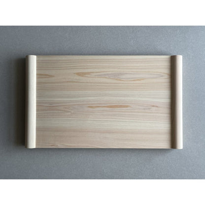 Wooden cutting board front view on a grey surface