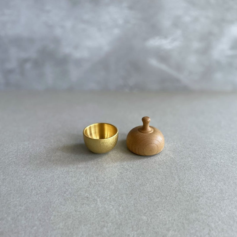 open healing bell with the top part next to the bowl