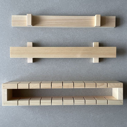 A wooden oshizushi mold divided in three parts