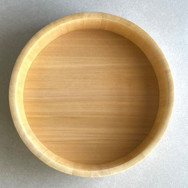 wooden bucket from upper view on a grey surface