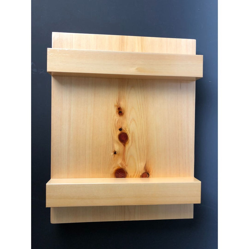 An image of an upside-down wooden sushi tray, with four wooden legs arranged in a bar-like formation, against a blue light surface. The bottom of the tray features a smooth and polished wooden surface with curved edges. The wooden legs are visible from this angle and appear to be sturdy and well-crafted. The blue light surface provides a striking and contemporary backdrop, adding a touch of color to the otherwise natural and organic composition.