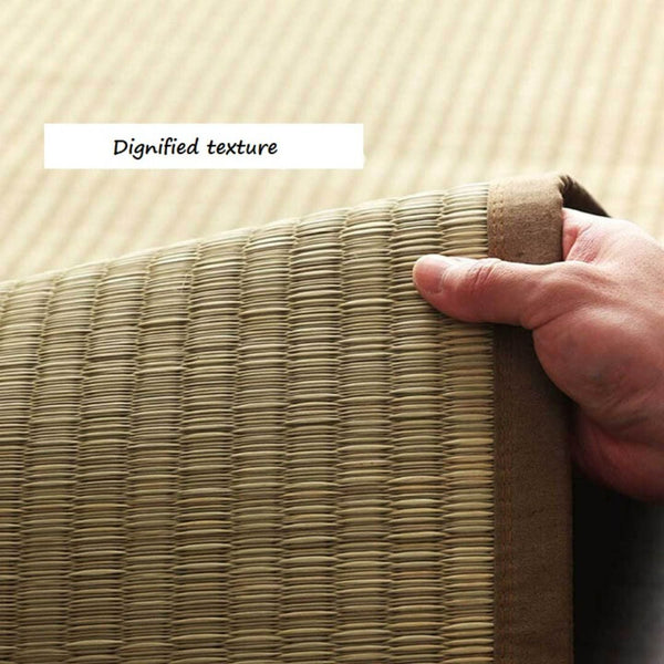 An hand holding a brown tatami rug showing its texture igusa grass