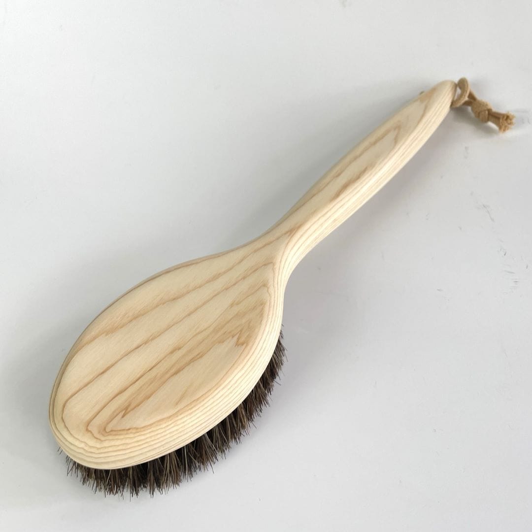A wooden body brush from back side