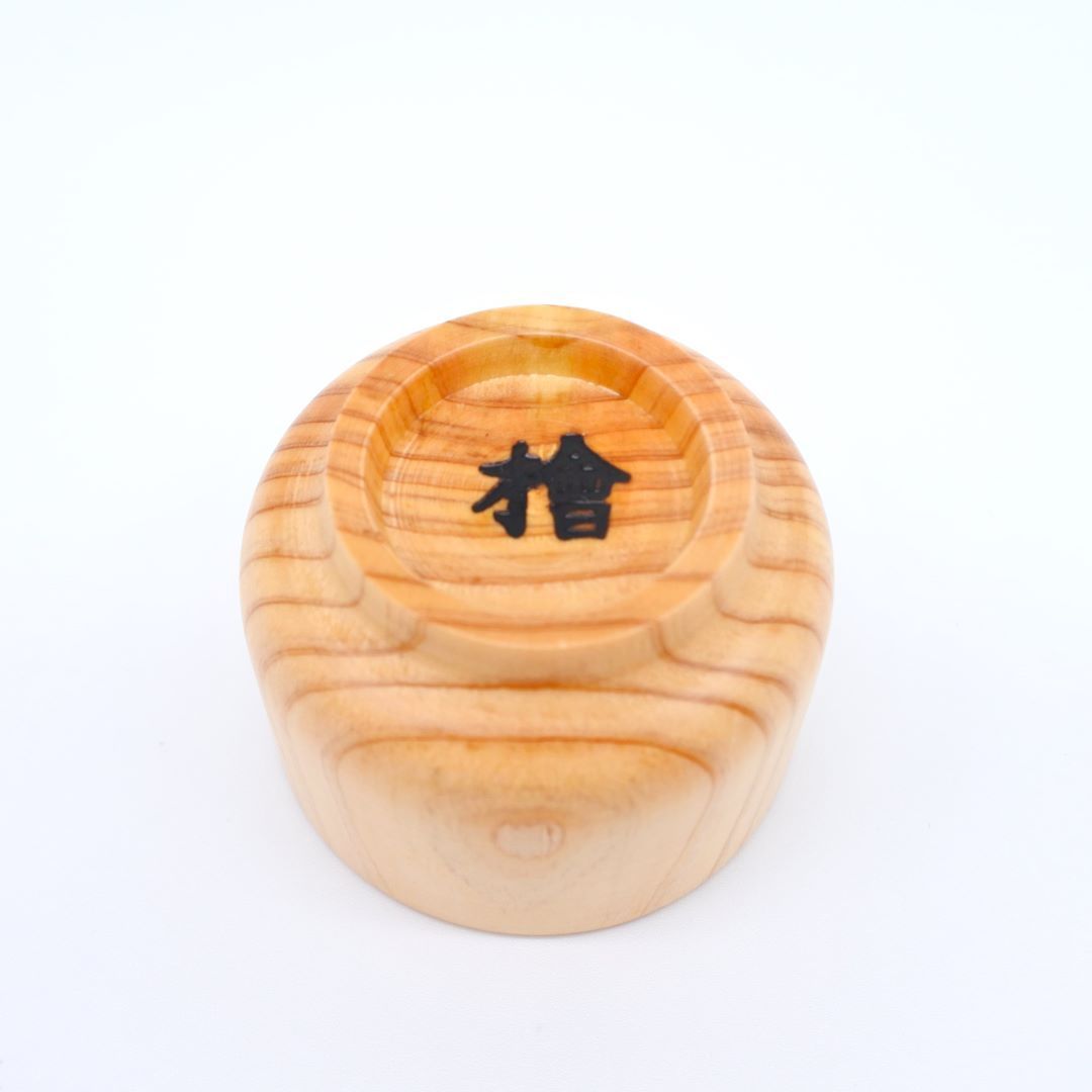 upside down the wooden sake cup on a white background