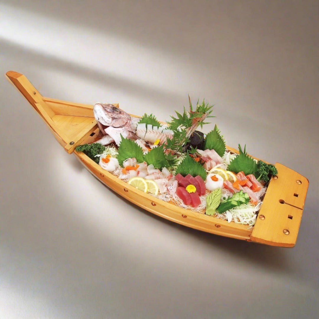 wooden sushi boat plate with raw fish inside on a wooden table